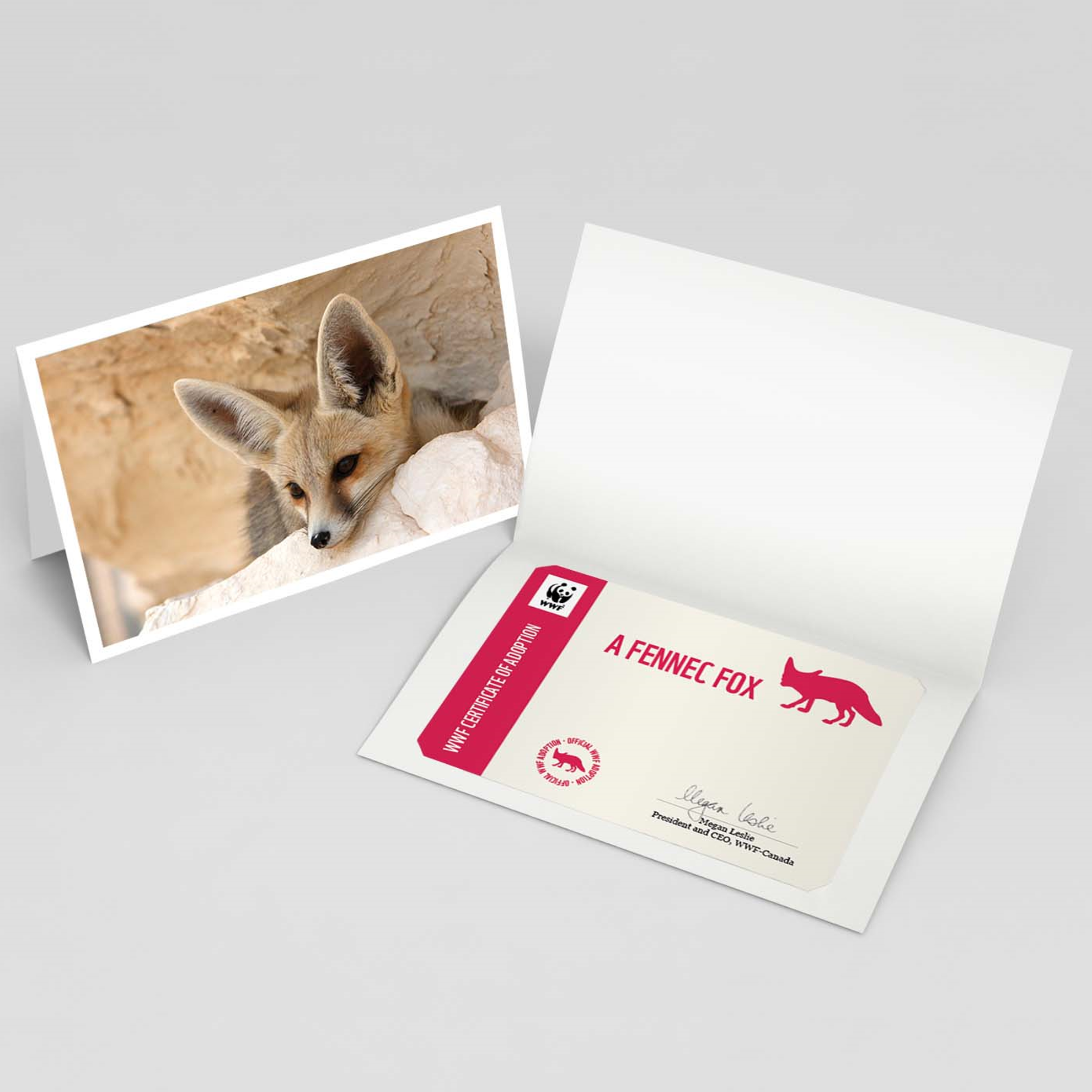Pictured on the left is the fennec fox adoption card cover featuring a picture of a fennec fox peaking out of a burrow. Beside it is the inside of the card containing a personalized fennec fox adoption certificate.